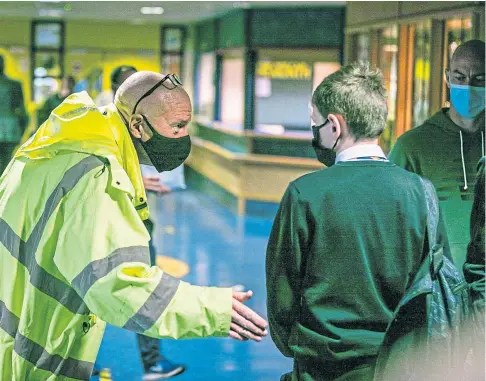  ??  ?? Kirkcaldy High School rector Derek Allan speaks to pupils about wearing face coverings. Picture by Steve Brown.