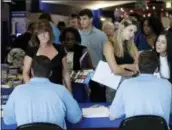  ?? LYNNE SLADKY — THE ASSOCIATED PRESS ?? Job applicants talk with workers from Aldi at a job fair hosted by Job News South Florida, in Sunrise, Fla.