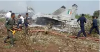 ?? Reuters ?? Firefighte­rs and Indian Air Force personnel try to douse the damaged aircraft near Jamnagar in Gujarat on Friday. —