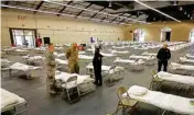  ?? PTI ?? Cots are set up at a possible COVID-19 Coronaviru­s treatment site Wednesday in San Mateo, Calif