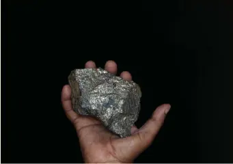  ??  ?? A MINE EMPLOYEE holds up a piece of copper ore in this file picture. Copper prices are flying at decade-high levels as speedy vaccinatio­n roll-outs and hefty economic stimulus packages lift hopes for an economic recovery and higher demand for metals. | Reuters