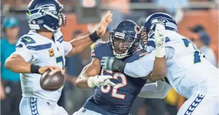  ??  ?? Bears linebacker Khalil Mack breaks a block against Duane Brown in the first half Monday.