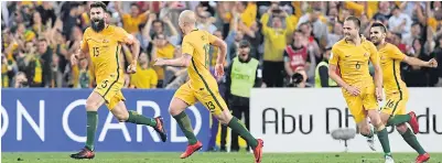  ?? AFP ?? Australia’s Mile Jedinak, left, celebrates scoring during their World Cup qualifying play-off match against Honduras at Stadium Australia in Sydney.