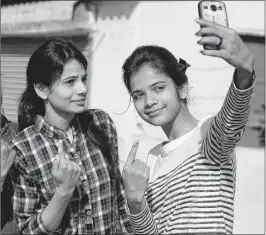  ?? PTI ?? First time voters take a selfie after casting their vote in Allahabad on Thursday.