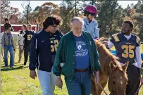  ?? Staff photo by Joshua Boucher ?? ABOVE BOTTOM RIGHT:Ella Grace Pickett, 7, rides a horse led by Runnin’ WJ Ranch volunteers and University of Central Oklahoma football players Friday at the ranch. Pickett is the daughter of the team’s head coach.