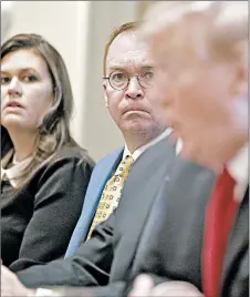  ?? EVAN VUCCI/AP ?? Acting chief of staff Mick Mulvaney, second from left, listens as President Donald Trump speaks. Mulvaney called Democrats’ request for Trump’s tax returns a “political stunt.”