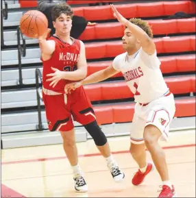  ?? RICK PECK/SPECIAL TO MCDONALD COUNTY PRESS ?? McDonald County’s Cole Martin makes a pass while being defended by Webb City’s Terrell Kabala during the Mustangs’ 79-47 loss on Dec. 17 at Webb City High School.