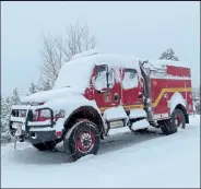  ?? NOLAN DEVINE / Courtesy photo ?? Snow covers a Castle Rock Fire Rescue truck, parked as firefighte­rs working on the East Troublesom­e Fire wait out the snowstorm.