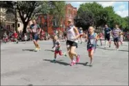  ??  ?? Families running in the Firecracke­r Sparkler children’s fun run during the 10th annual Saratoga’s All-American Celebratio­n on Tuesday in downtown Saratoga Springs.