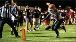  ?? ALLEN EYESTONE / THE PALM BEACH POST ?? Palm Beach Gardens running back Antonio Outler fumbles out of the end zone in overtime for a touchback that preserved a Seminole Ridge win.