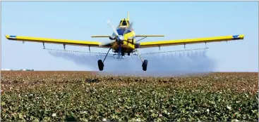  ?? AP PHOTO BY GARY KAZANJIAN ?? In this 2001 file photo, a crop dusting plane from Blair Air Service dusts cotton crops in Lemoore.