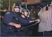  ?? Frederic J. Brown AFP/Getty Images ?? POLICE use batons to disperse a crowd gathered after Friday’s Roe vs. Wade protest in downtown L.A.