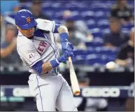  ?? Wilfredo Lee / Associated Press ?? The New York Mets’ Javier Baez hits a ground-rule double during the first inning against the Miami Marlins on Thursday.