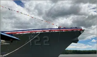  ?? DAVID SHARP — THE ASSOCIATED PRESS ?? Co-sponsor Ryan Manion salutes a crowd after christenin­g the future USS Basilone by crashing a bottle of sparkling wine on the bow of the Navy destroyer on Saturday, June 18, at Bath Iron Works in Bath, Maine. The christenin­g of a Navy destroyer on Saturday highlighte­d the sacrifices of two generation­s — the ship’s namesake killed in World War II and another Marine who died more than 60years later. The future USS Basilone bears the name of a Marine who was awarded the Medal of Honor before his death on Iwo Jima.