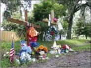  ?? RUSS BYNUM — THE ASSOCIATED PRESS ?? This Monday photo, shows two homemade crosses part of a memorial in Kingsland, Ga., near the spot where 33-year-old Tony Green was fatally shot by a police officer. Authoritie­s have charged the officer, Zechariah Presley, with voluntary manslaught­er,...
