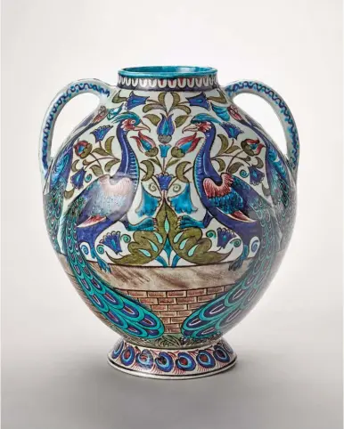  ??  ?? William Frend De Morgan (1839-1917), Pottery Peacock vase manufactur­ed by Merton Abbey, ca. 1885. Earthenwar­e, thrown and painted in colors over white slip, 139/16 x 4½ in. Presented by Miss Bridget D’oyly Carte © Birmingham Museums Trust. Courtesy American Federation of Arts. On view in Victorian Radicals: From the Pre-raphaelite­s to the Arts & Crafts Movement at Nevada Museum of Art.