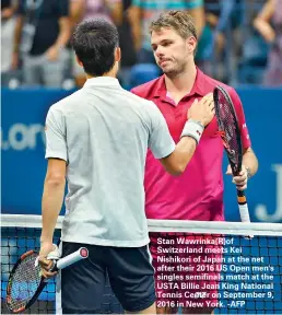  ??  ?? Stan Wawrinka(R)of Switzerlan­d meets Kei Nishikori of Japan at the net after their 2016 US Open men's singles semifinals match at the USTA Billie Jean King National Tennis Center on September 9, 2016 in New York. -AFP