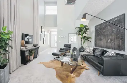  ??  ?? The great room with an open-to-above ceiling provides an airy space for visitors at the Tempo duplex show home in Carrington.