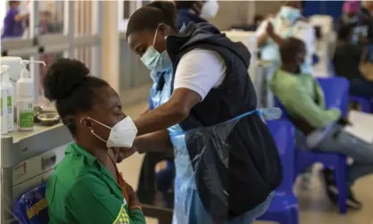  ?? Photograph: Themba Hadebe/AP ?? Healthcare workers being vaccinated in Johannesbu­rg, South Africa.