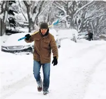  ?? DARREN MAKOWICHUK ?? Dion Lobreau was kept busy shovelling snow yet again after the city received another record amount on Saturday.