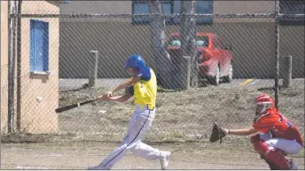  ?? JEANS PINEDA/Taos News ?? Donivan Aguilar connects for a double on Saturday (March 26).