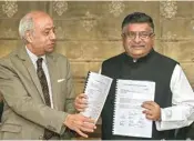  ??  ?? Union Law Minister Ravi Shankar Prasad accepts a report on ‘Data Protection Framework’ from Justice BN Srikrishna, in New Delhi