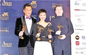  ??  ?? (Left to right) Louis Koo, Sylvia Chang (Best Actress for ‘Love Education') and Feng Xiaogang (Best Film for'Youth') pose with their awards backstage.