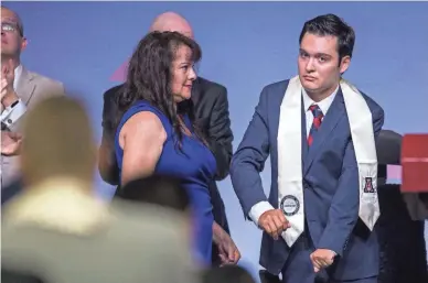  ??  ?? Hermelinda Bristol watches as her son, Jeffrey, 24, is recognized during convocatio­n on May 11.