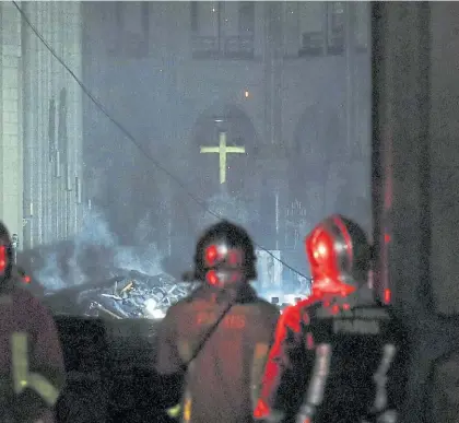  ?? EFE ?? Desolación. Bomberos observan los daños en el interior de la catedral tras haberse apagado las llamas.