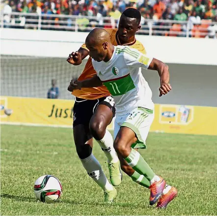  ??  ?? Eyes on the ball: Algeria forward Yacine Brahimi (front) vying for the ball with Zambia forward Brian Mwila during the World Cup qualifying Group B match at the Heroes Stadium in Lusaka on Saturday. — AFP