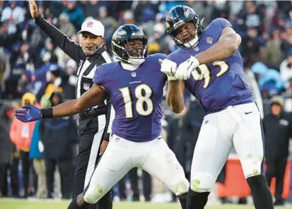  ?? KENNETH K. LAM/BALTIMORE SUN ?? Ravens linebacker Roquan Smith, left, celebrates with defensive lineman Calais Campbell after Campbell got a sack against the Panthers on Nov. 20.