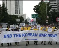  ?? (AP/Ahn Young-joon) ?? Participan­ts march during a rally for peace unificatio­n of the Korean peninsula on Saturday in Seoul, South Korea.