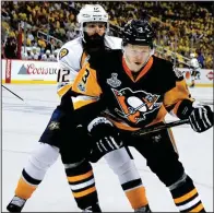  ?? AP/ KEITH SRAKOCIC ?? Pittsburgh defenseman Olli Maatta ( front) cuts off Nashville center Mike Fisher while chasing for the puck during Game 1 of the Stanley Cup Final on Monday night. The Penguins had only 12 shots, but it was enough to beat the Predators 5- 3.