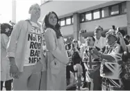  ?? LEFTERIS PITARAKIS/ THE ASSOCIATED PRESS ?? Royal supporters take photos as a couple impersonat­e Britain’s Prince William and Kate outside the hospital on Friday.