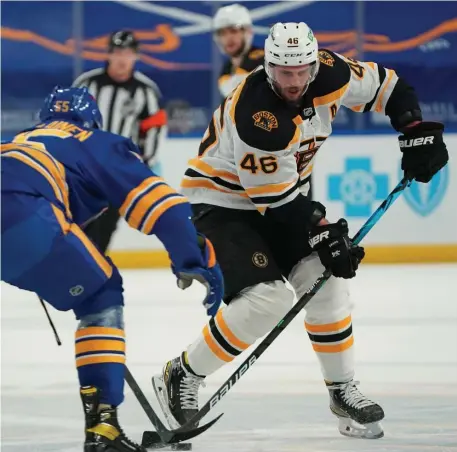  ?? Getty iMages ?? PLAYMAKER GETTING ON TRACK: Bruins center David Krejci, right, skates up ice with the puck as Buffalo’s Rasmus Ristolaine­n defends at KeyBank Center in Buffalo, N.Y., on Thursday night. Krejci had three assists to help lead the Bruins to the victory.