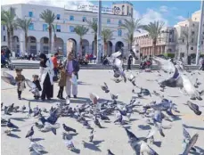  ?? — AFP ?? A family poses at Martyr’s Square in Libya’s capital Tripoli.