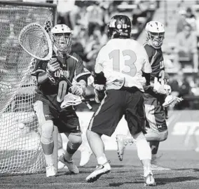  ?? KIM HAIRSTON/BALTIMORE SUN ?? Loyola goalkeeper Jacob Stover is beaten by Johns Hopkins’ Kyle Marr during the third quarter. The sophomore attackman finished the game with two goals.