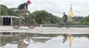  ?? — AFP ?? Riders from Myanmar BMX Rider perform during an event at People’s Park in Yangon.