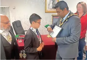  ?? ?? ● Andrew Perez, 11, was invited to meet the Mayor of Rochdale, Ali Ahmed, and was presented with his award