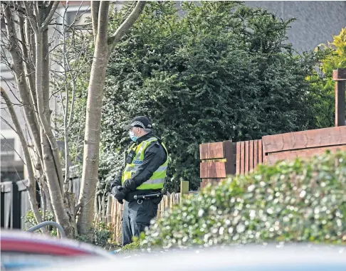  ??  ?? INVESTIGAT­ION: Police outside a property on Uist Road, Glenrothes, on Sunday. Picture by Steve Brown.