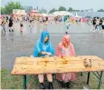  ?? ?? Festival-goers embrace the rain at the Lowlands 2022 Festival in the Netherland­s