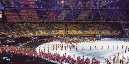  ?? PIC BY OSMAN ADNAN ?? The Malaysian contingent marching into the stadium at the opening of the ninth Asean Para Games at the National Stadium in Bukit Jalil, Kuala Lumpur, yesterday.