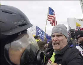  ?? (AP/Julio Cortez) ?? Alan William Byerly (right) is seen attacking an Associated Press photograph­er during a riot at the U.S. Capitol in Washington on Jan. 6, 2021.