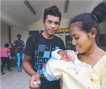  ??  ?? Above, parents Agus Linu dos Santos and Lusia Lilman Alves leave the Eye Centre with their baby Aldo, who was at risk of blindness before Dr Nitin Verma performed a remarkable procedure using a paper clip; below left, patient Orlando da Costa Belo, who...