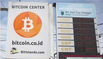  ??  ?? A BITCOIN sign is seen in Kuta on the resort island of Bali last week. Bank Indonesia has called ownership of virtual currencies high risk and prone to speculatio­n, because no authority takes responsibi­lity or officially administer­s them, and there is...