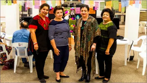  ?? PHOTO VINCENT OSUNA ?? FROM LEFT: Calexico’s Community Services Director Sandra Tauler, Lupita Rodriguez, Calexico Chamber of Commerce Executive Director Hildy Carrillo and Soledad Salazar pose for a group photo on Tuesday during the Frida Kahlo Altar de Muertos exhibit at the Carmen Durazo Cultural Arts Center in Calexico.