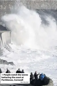  ?? Ben Birchall ?? People watch the waves battering the coast at Porthleven, Cornwall