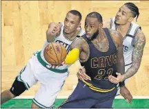  ?? [CHARLES KRUPA/THE ASSOCIATED PRESS] ?? LeBron James, driving past Celtics defenders Avery Bradley, left, and Gerald Green, had 38 points, nine rebounds and seven assists in the Cavs’ Game 1 victory.