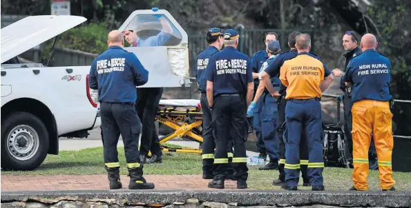  ??  ?? A rescue officer carries one of the doors from the sightseein­g DHC-2 Beaver seaplane which crashed in the Hawkesbury River near Sydney yesterday