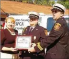  ?? GIL COHEN – DIGITAL FIRST MEDIA ?? Former Malvern Fire Co. Chief Paul Wilkins, center, along with thenAssist­ant Chief Neil Vaughn, right, accept a citation from SPCA Developmen­t Director Linda Kaat in August 2009. The firefighti­ng duo were commended for their actions in saving two dogs...